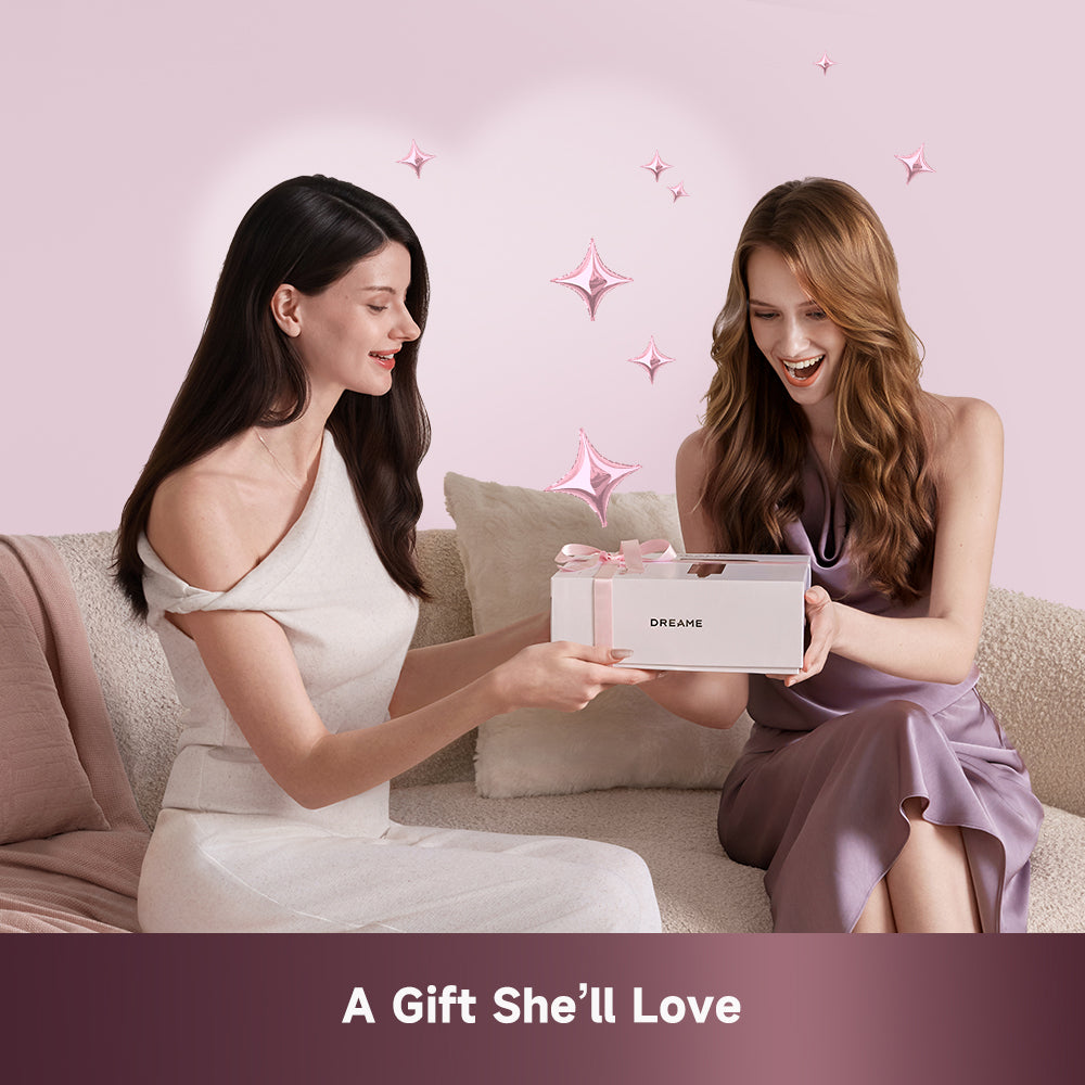 Pocket hair dryer with rose-gold finish held by a woman with gift box
