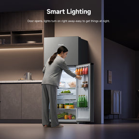 Open double door refrigerator with illuminated interior compartments