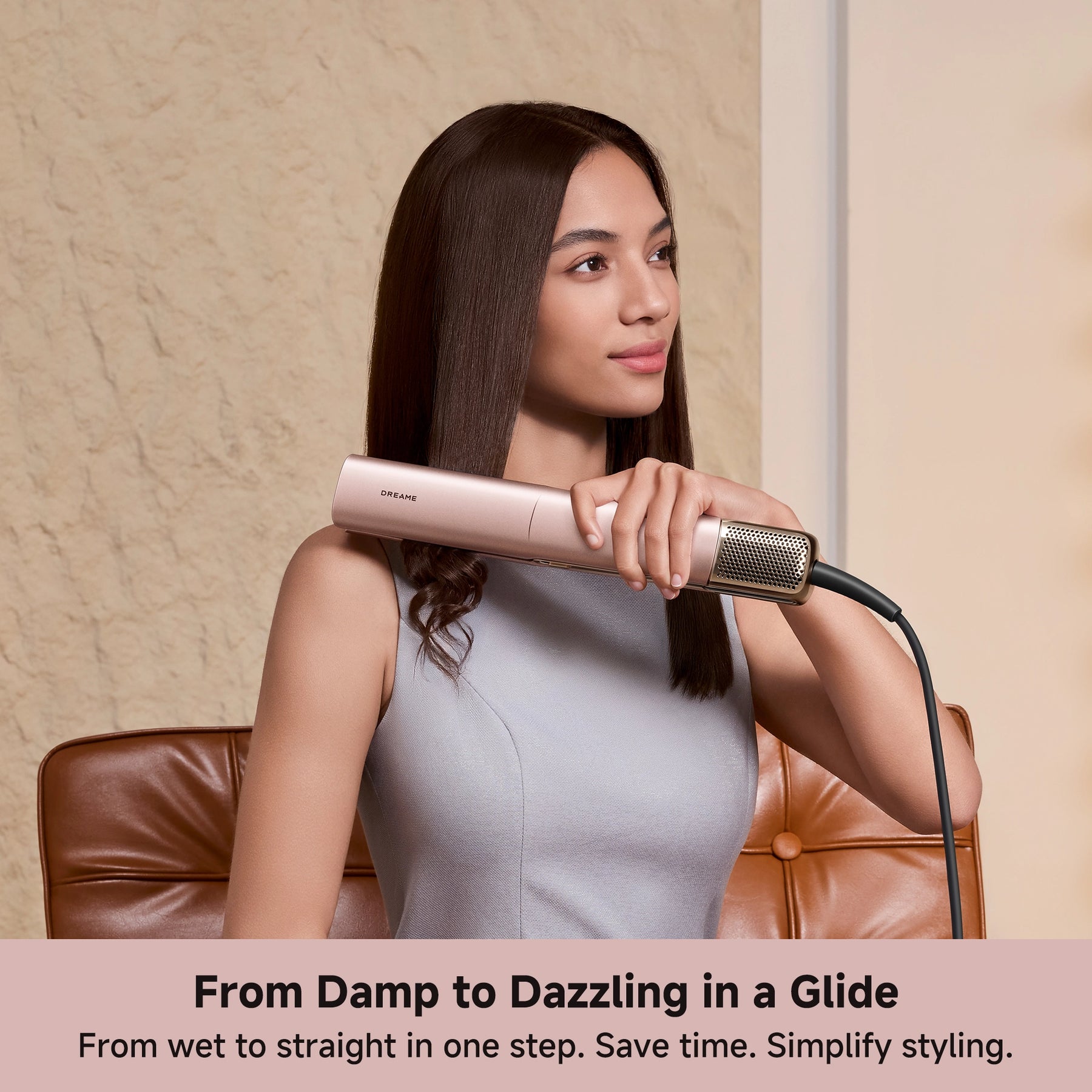 Rose-gold air straightener smoothing dark hair along the tool barrel
