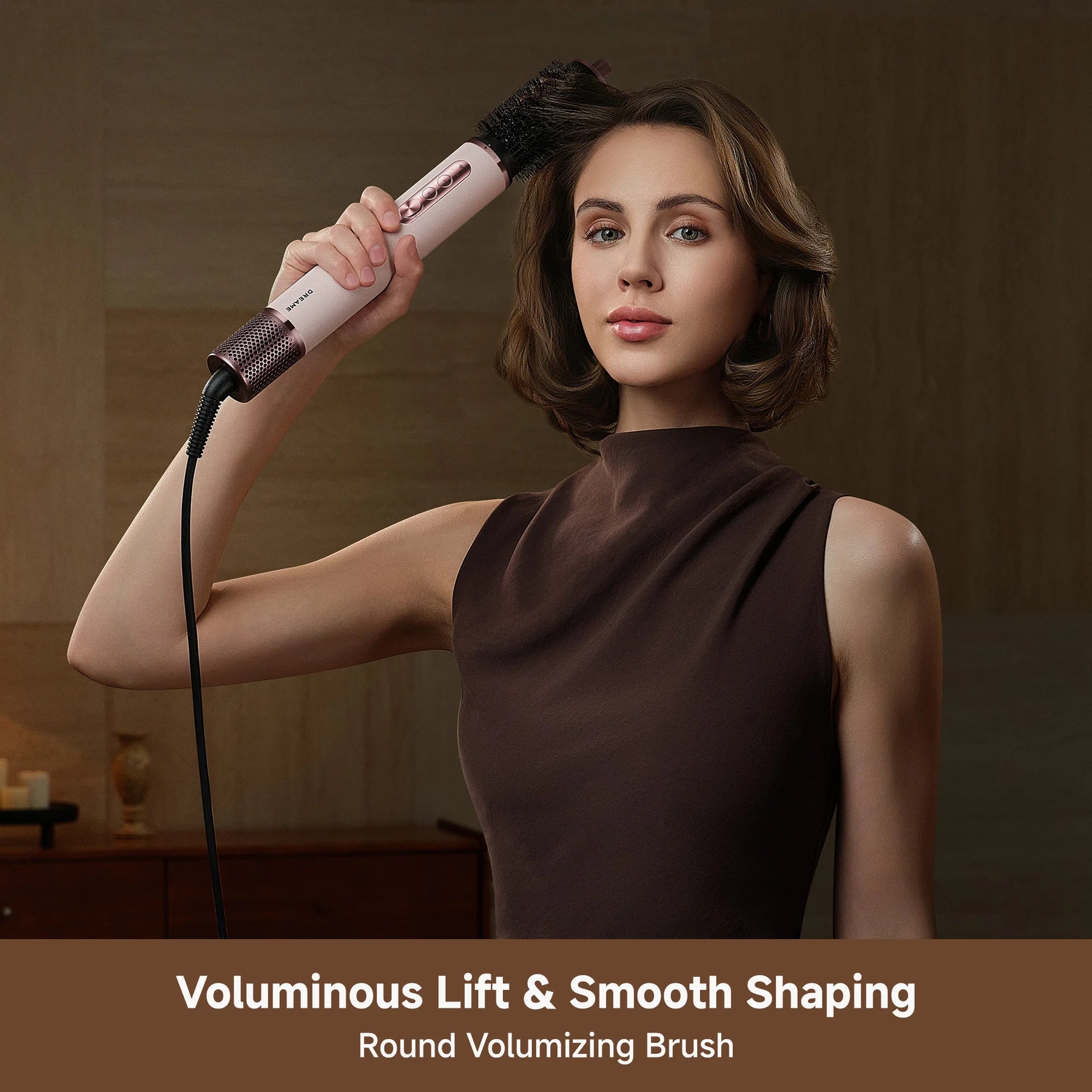 Hair styler held by handle with round brush barrel attachment and smooth airflow